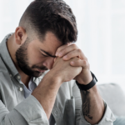 A professional and supportive banner for a Florida disability law firm. On the left, a soft-focus image of a person sitting by a window, reflecting the quiet struggle of mental health. On the right, clean text reads "Can I Get SSDI for Depression and Anxiety in Florida?" with a call to action for a free consultation at Quin Baker Law.